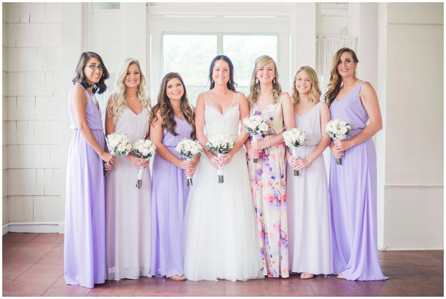 Bride with maids wearing purple dresses at a Minneapolis golf course wedding. Photo by Kayla Lee.