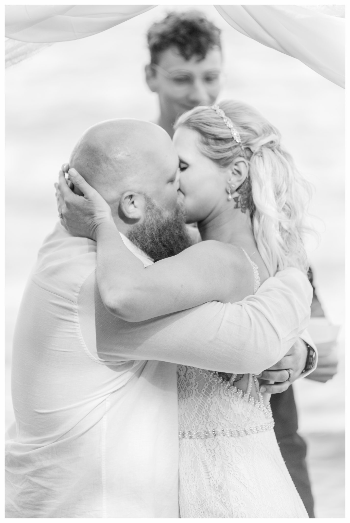 First kiss from a summer Bluefin Bay Wedding. Photo by Kayla Lee.