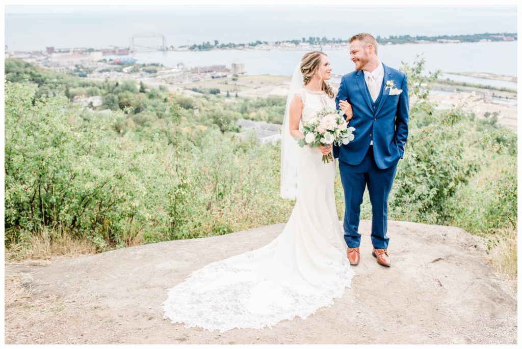 Wedding portraits at Enger Tower. Summer wedding at Clyde Iron Works in Duluth, Minnesota. Photo by Kayla Lee.