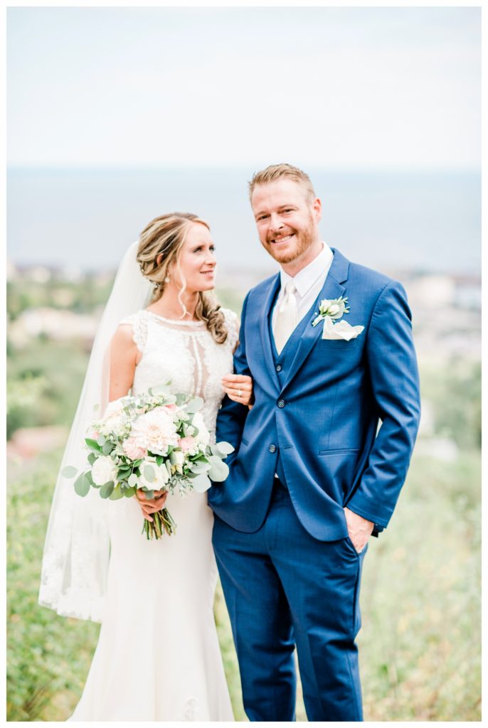 Wedding portraits at Enger Tower. Summer wedding at Clyde Iron Works in Duluth, Minnesota. Photo by Kayla Lee.