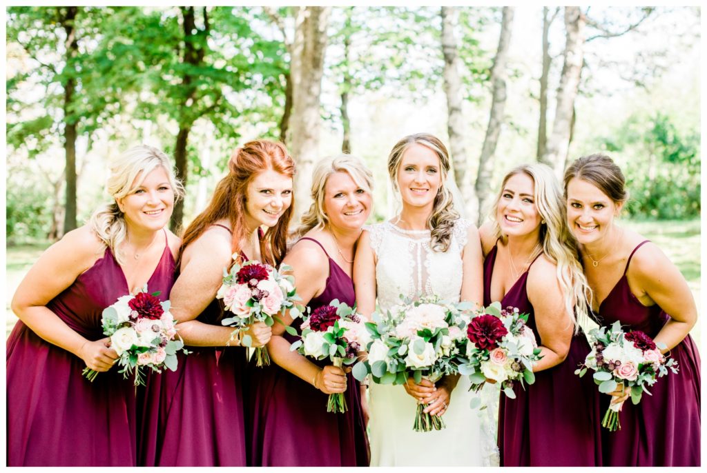 Bridal party portraits at Enger Tower. Summer wedding at Clyde Iron Works in Duluth, Minnesota. Photo by Kayla Lee.