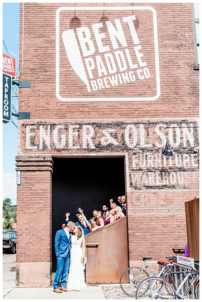 Wedding portraits at Bent Paddle Brewing. Summer wedding at Clyde Iron Works in Duluth, Minnesota. Photo by Kayla Lee.