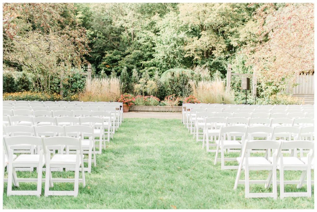 An outdoor ceremony for a maroon and gold fall wedding at the Minnesota Landscape Arboretum. Photography by Kayla Lee.
