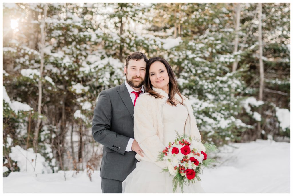 A red and green Christmas-inspired winter elopement at Gunflint Lodge. Photography by Kayla Lee.