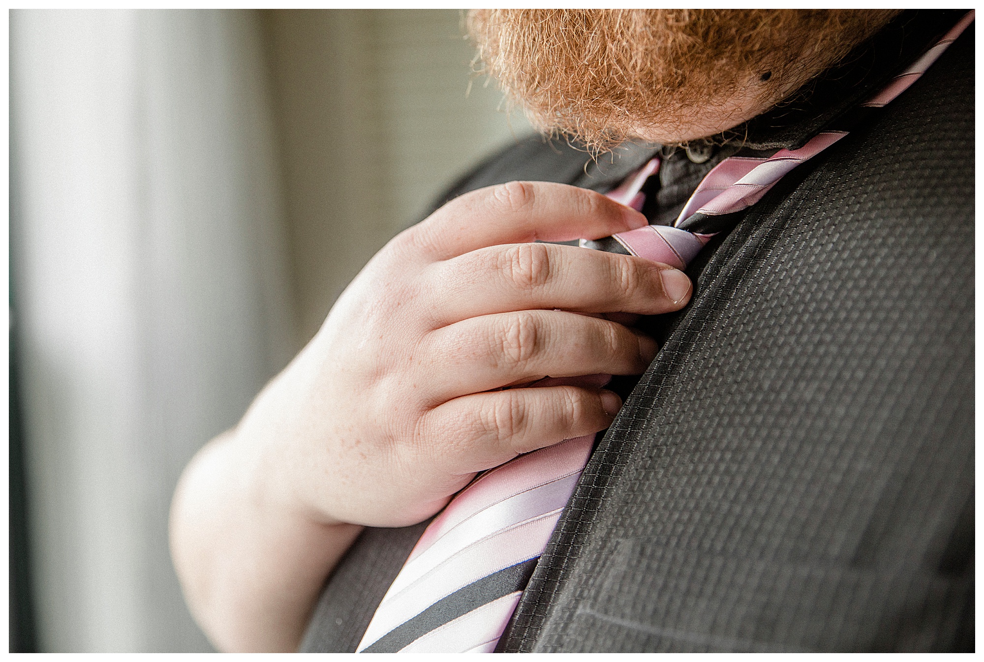Groom tying tie for Minneapolis wedding.