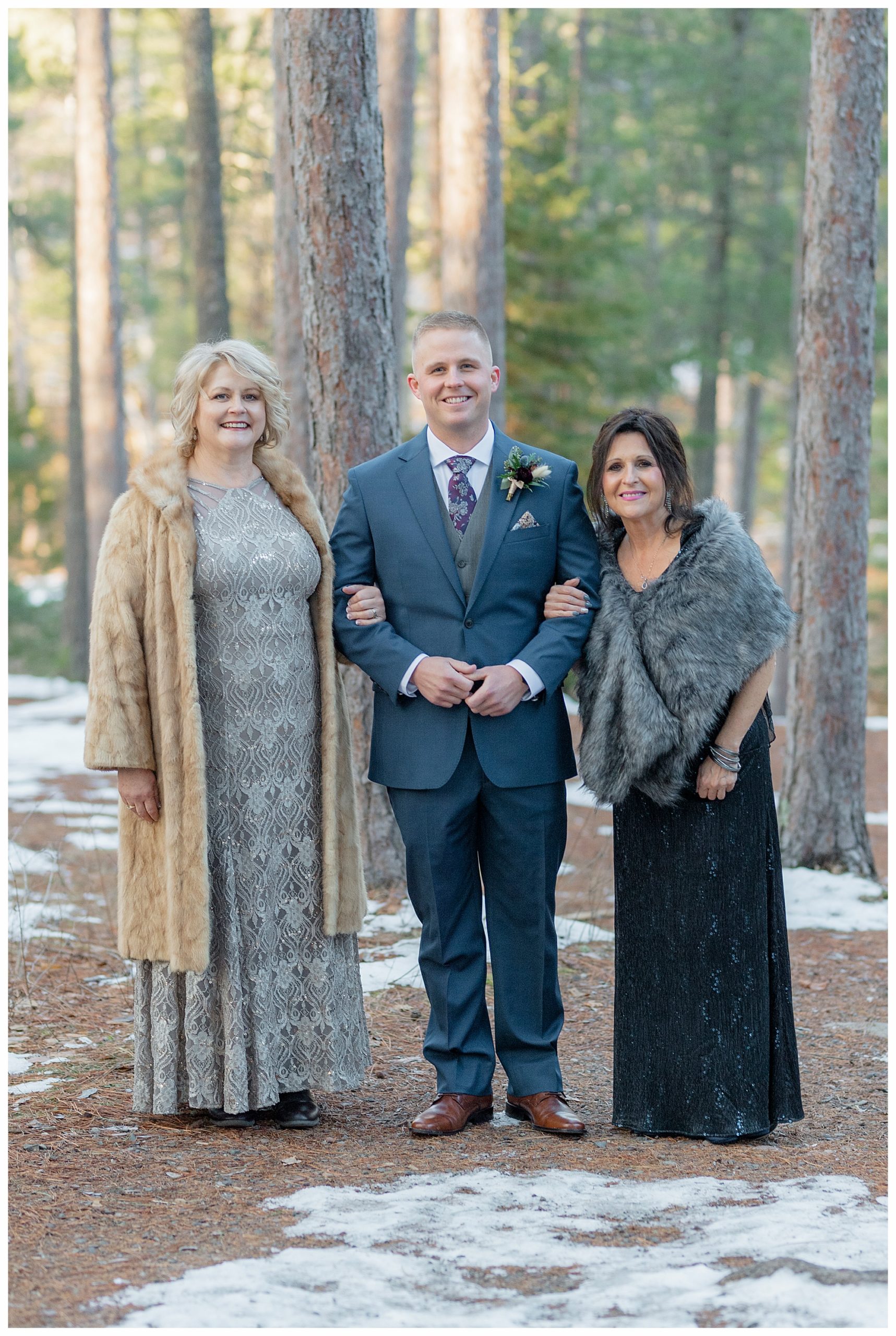 Groom with the mothers at a navy and maroon/burgundy state park fall elopement. Photo by Kayla Lee.