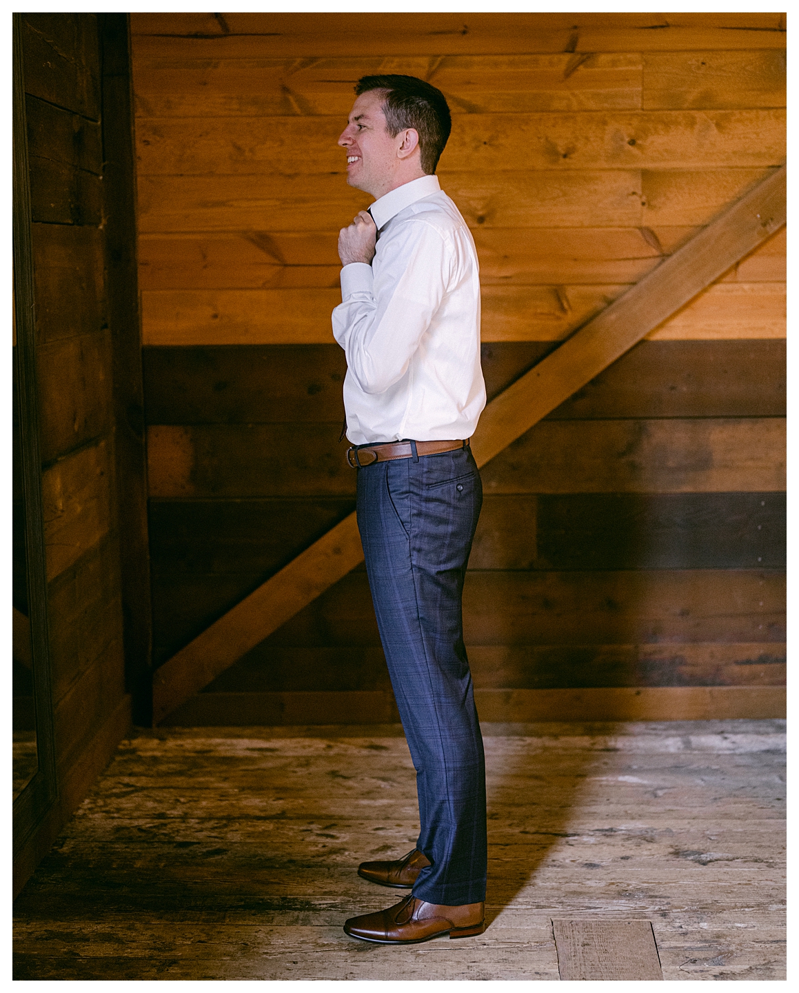 A groom getting ready in the barn at a Mayowood Stone Barn Wedding. Photo by Kayla Lee.